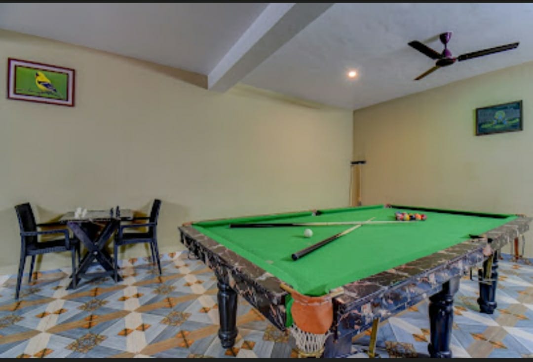 Indoor activities room with professional green-felt pool table